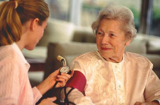 pielęgniarka mierzy ciśnienie starszej osobie